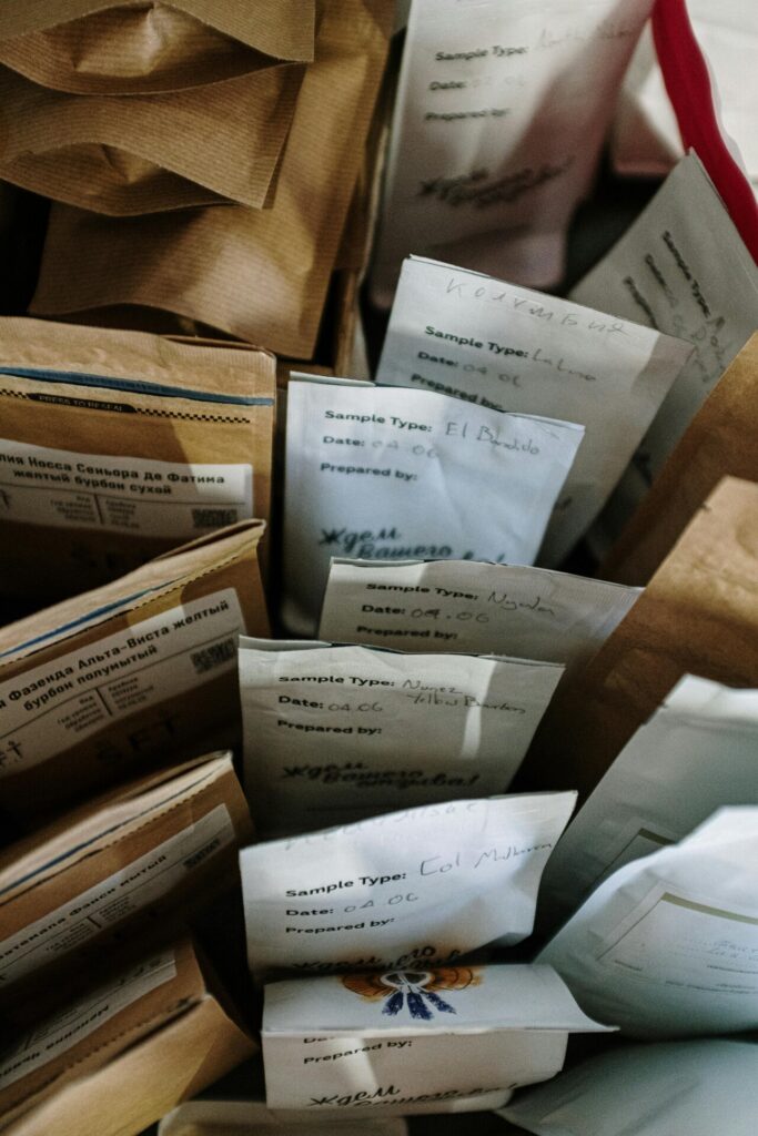 Overhead view of various coffee sample bags with labels, ideal for coffee enthusiasts.